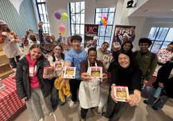 group photo of students, faculty, and staff holding pies for pi day